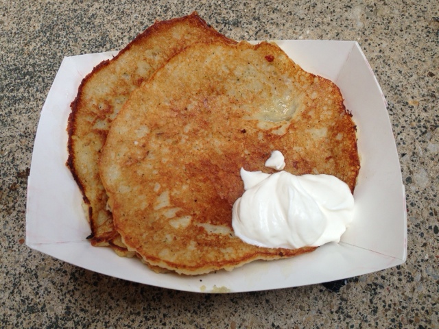 A generous serving of potato pancake with sour cream.