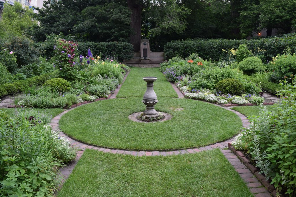 Sundial at the center of the four rectangular beds