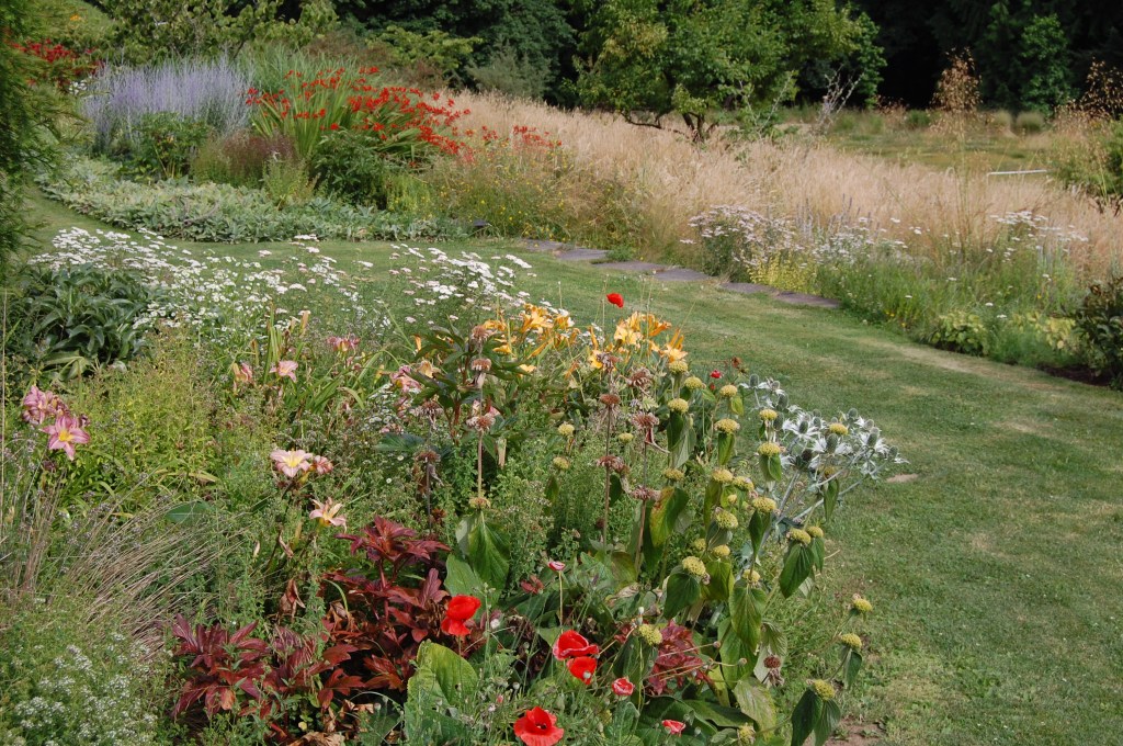 A grass path leads to the gardens.