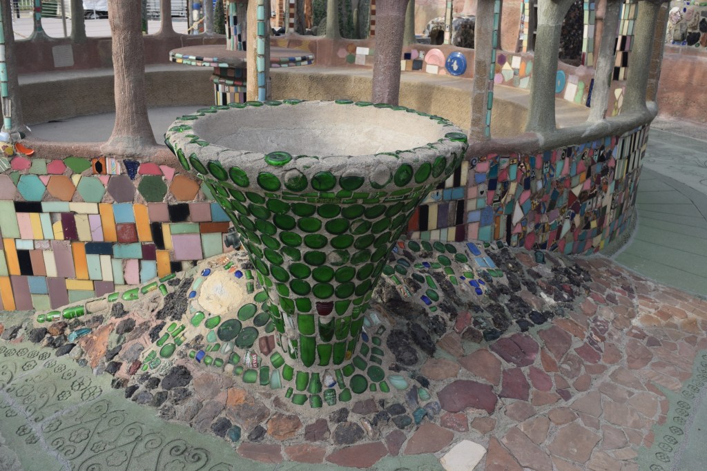 A baptismal font decorated with broken bottles. Rodia eventually became a Pentecostal minister.