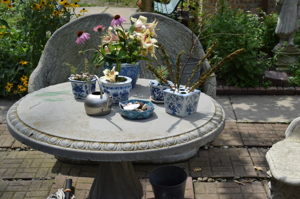A small table with a variety of decorative pots.